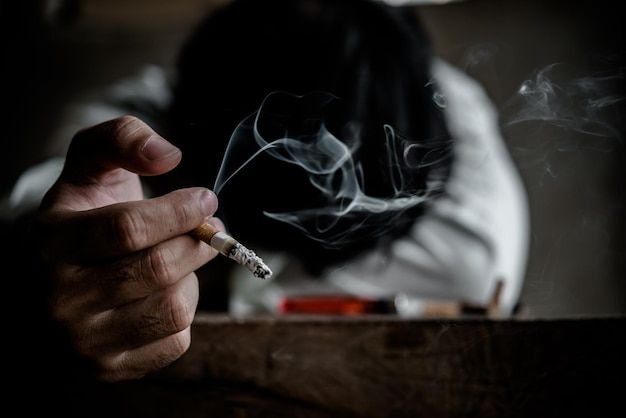 Asian Stress man smokingThailand peopleNo tobacco day conceptDIe from smoke smoking cigarette _ Premium Photo